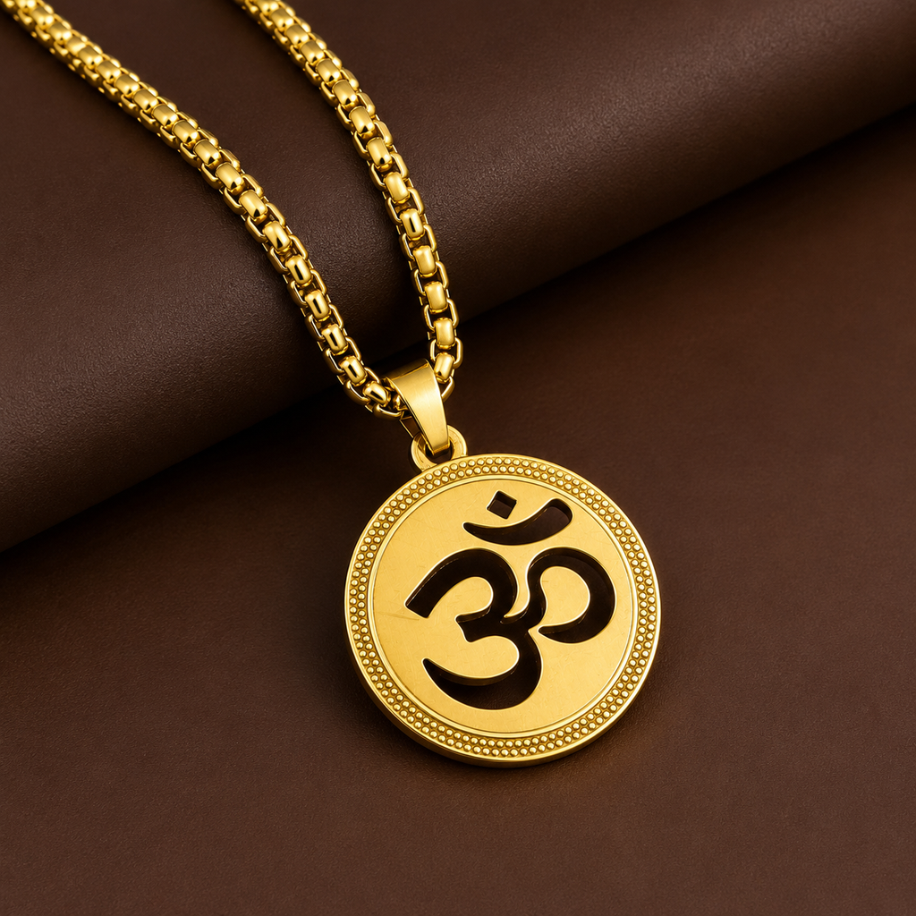 A gold-tone necklace with a round medallion pendant featuring a black Om symbol, displayed on a dark brown textured background.
