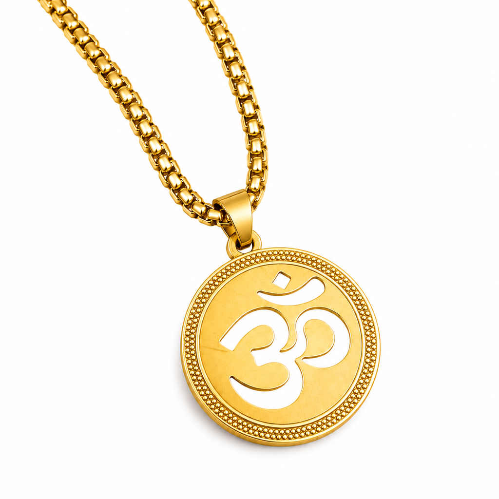 A gold chain necklace with a round pendant featuring a cutout Om symbol, set against a plain white background.